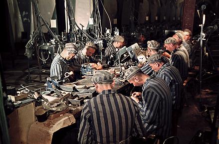 Electric Work by Slave Laborers in Underground Factory, photograph by Walter Frentz. See Camera Light at Back Right, as well as Prisoner Looking at Camera. The Prisoner, Léon Navaro from Grenoble, identified himself when the Frentz photographs surfaced 55 years later. Courtesy of Hanns-Peter Frentz/Amicale des déportés de Dora-Ellrich.