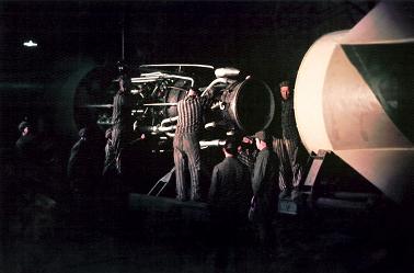 Slave laborers during final Assembly of a V-2 with German Civilian Observing. Courtesy of Hanns-Peter Frentz/Amicale des déportés de Dora-Ellrich.